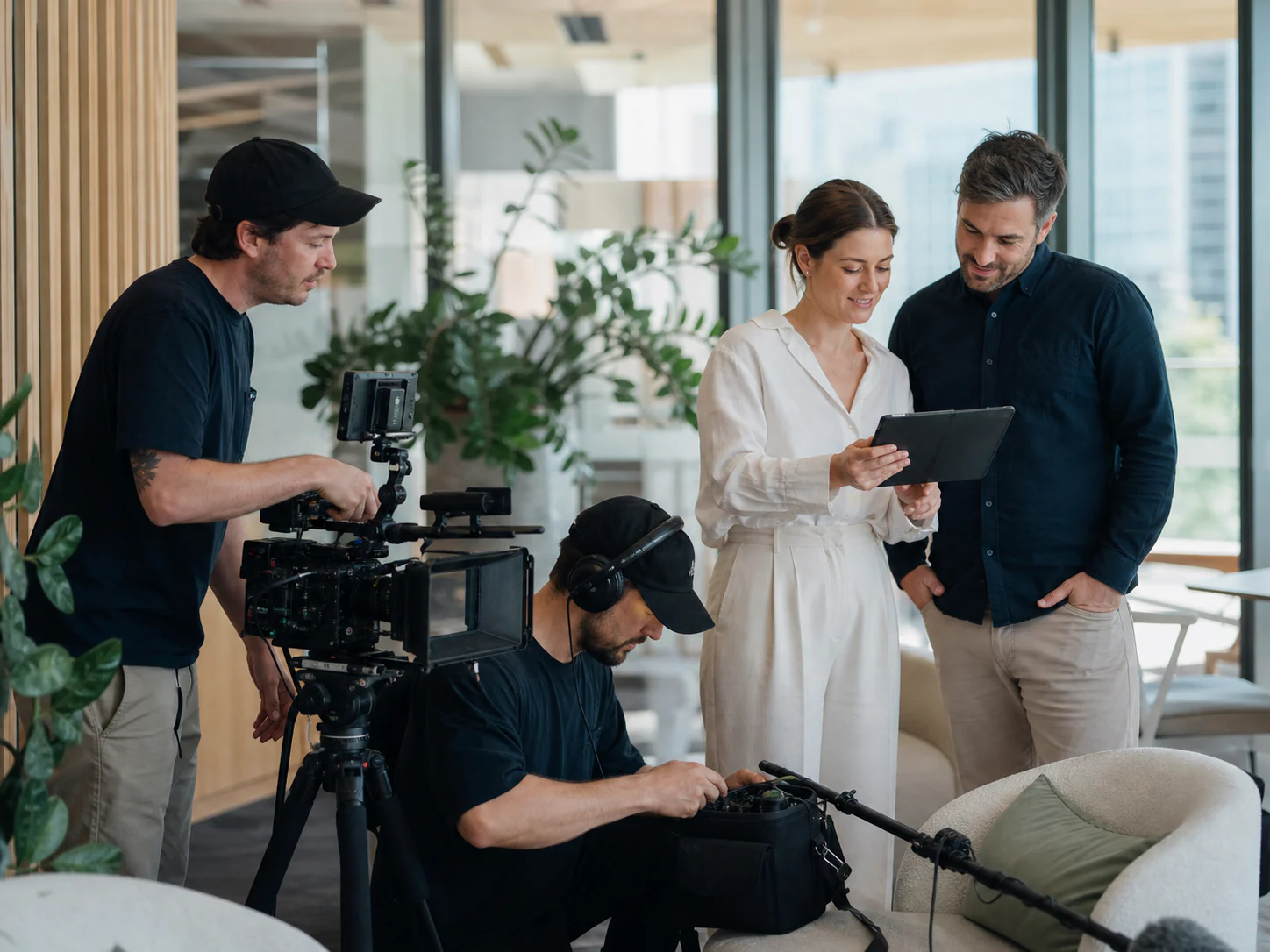 A video crew and clients calmly preparing for a tailored shoot.