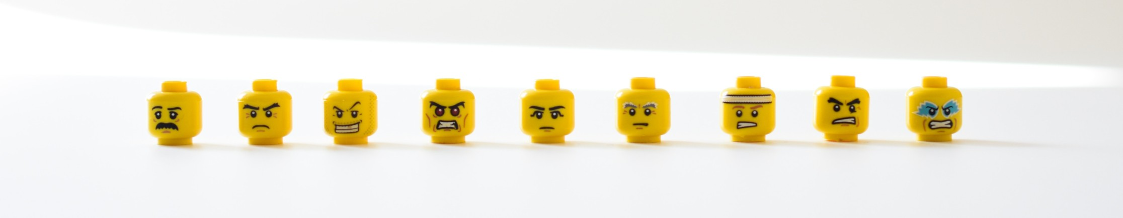 A row of expressive toy heads showing different emotional reactions