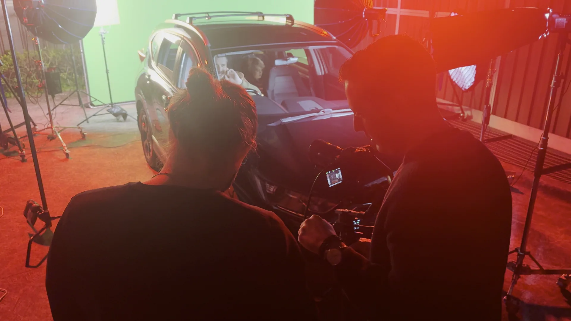 Crew behind camera watching actor